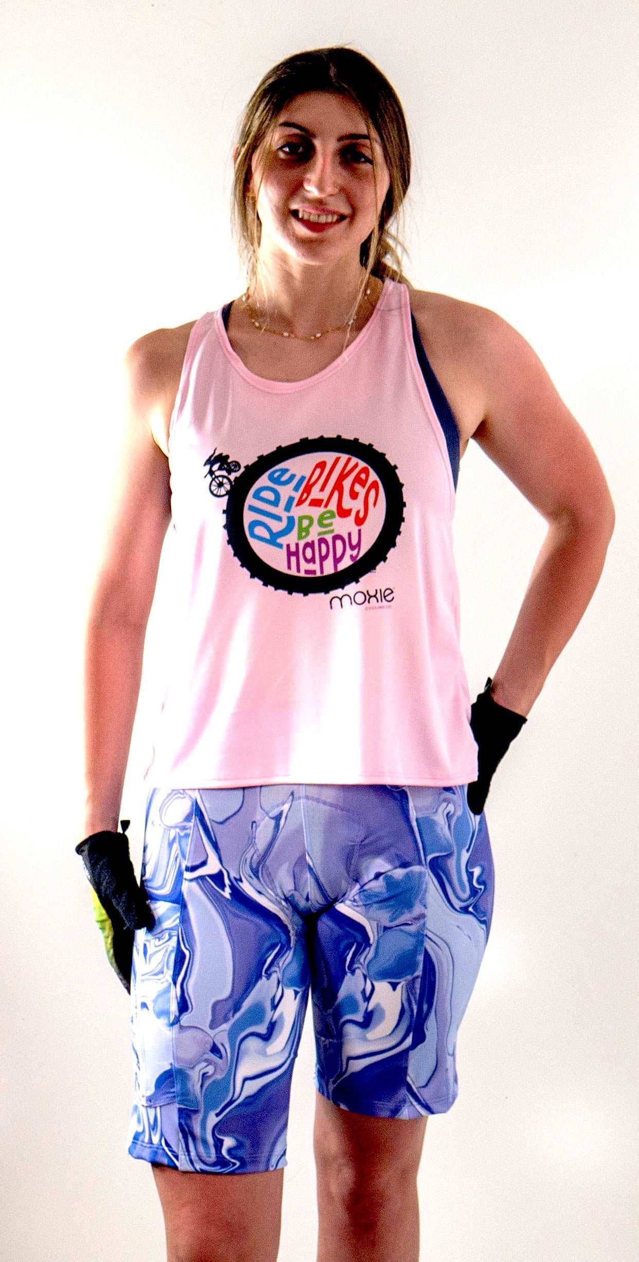 Ride Bikes Be Happy Tank in pink, featuring light mesh fabric and loose mountain bike style, worn by a person.